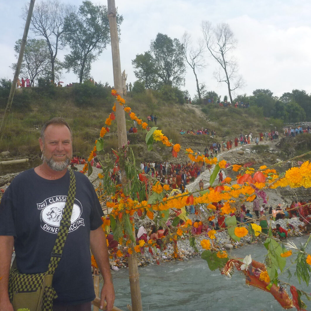 Man looking at camera with long line of people