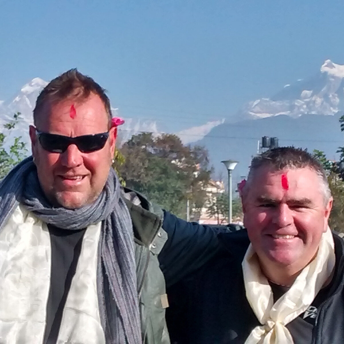 Two men looking at camera Nepal mountains in background